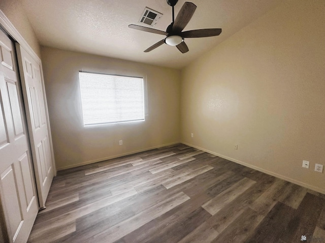 unfurnished bedroom with baseboards, visible vents, and wood finished floors