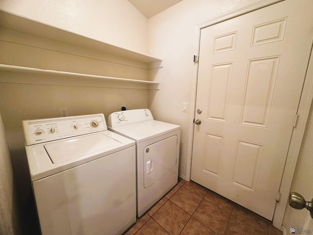 clothes washing area featuring laundry area, separate washer and dryer, and tile patterned flooring