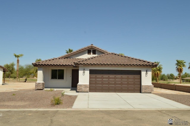 mediterranean / spanish-style home with a garage