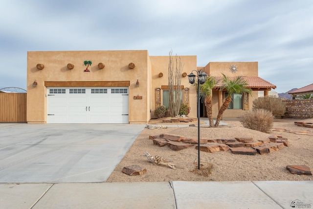 adobe home featuring a garage