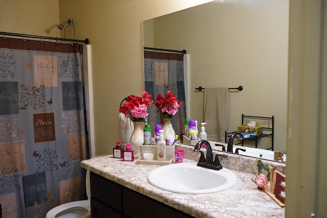 bathroom featuring a shower with curtain, vanity, and toilet