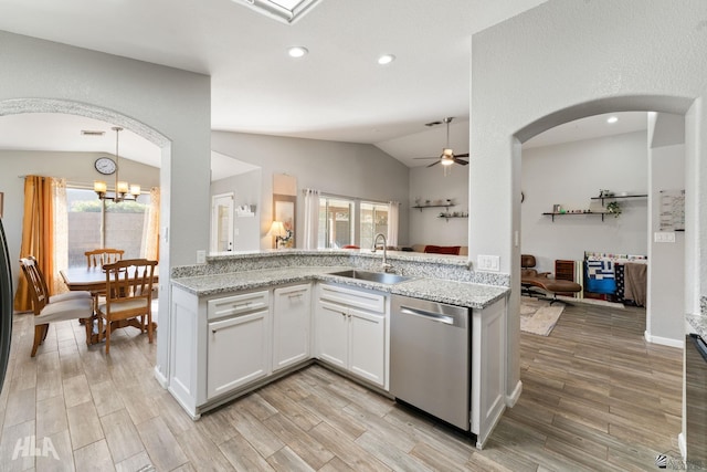 kitchen with white cabinetry, stainless steel dishwasher, lofted ceiling, and sink