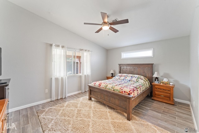 bedroom with ceiling fan, light wood-type flooring, and lofted ceiling