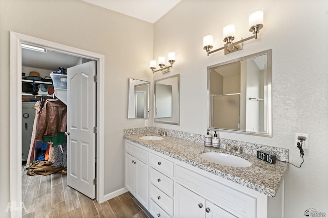 bathroom with vanity and a shower with door