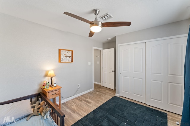 bedroom with a closet, ceiling fan, and light hardwood / wood-style floors