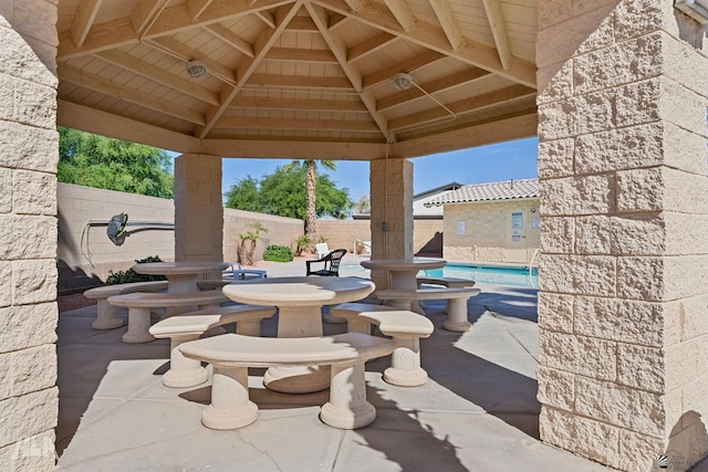 view of patio featuring a gazebo and a community pool