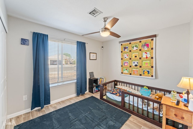 bedroom with ceiling fan and light hardwood / wood-style flooring