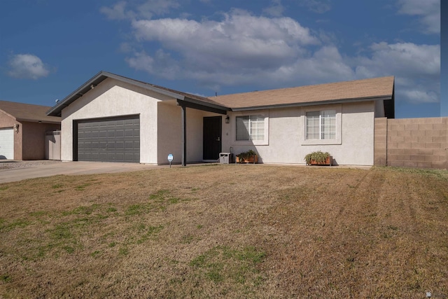 ranch-style home featuring a garage and a front lawn