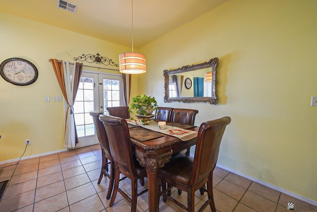 dining area with tile patterned flooring and french doors