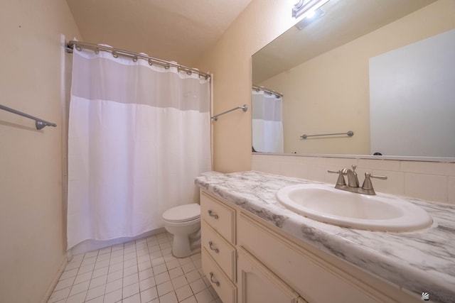 bathroom featuring toilet, a shower with shower curtain, tile patterned flooring, and vanity