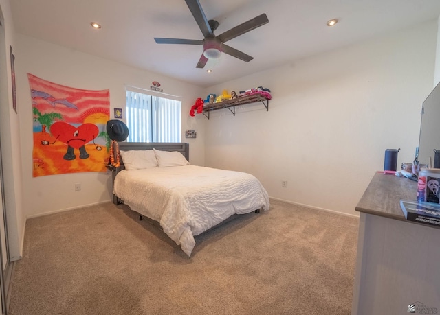 bedroom with ceiling fan and light colored carpet