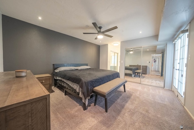 bedroom with ceiling fan, light colored carpet, and multiple windows