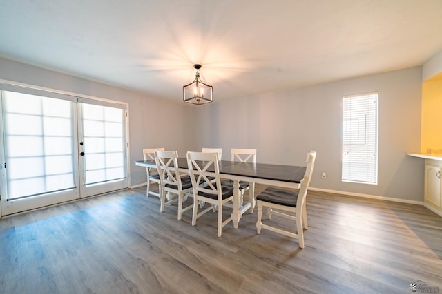 dining space with an inviting chandelier and hardwood / wood-style flooring