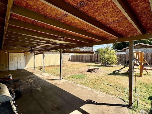 view of patio / terrace featuring a playground and an outdoor fire pit