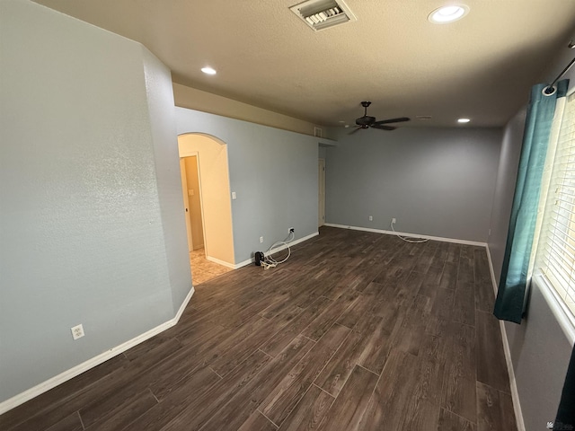 spare room with ceiling fan and dark hardwood / wood-style flooring