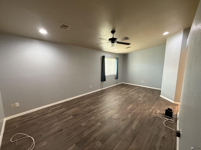 empty room with ceiling fan and dark hardwood / wood-style floors