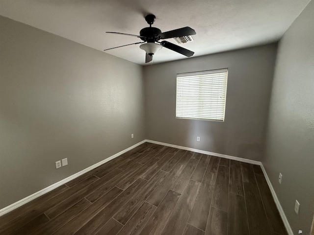 spare room featuring dark hardwood / wood-style flooring and ceiling fan