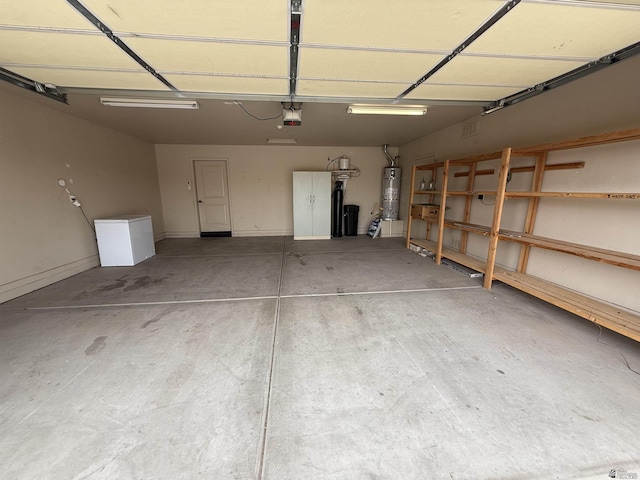 garage with a garage door opener and secured water heater