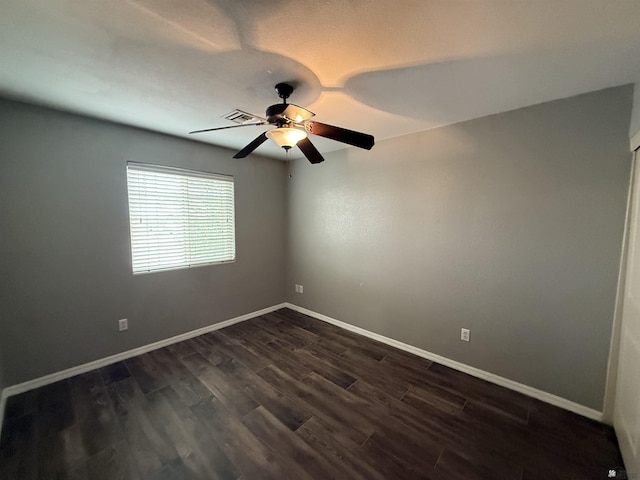 empty room with ceiling fan and dark hardwood / wood-style floors