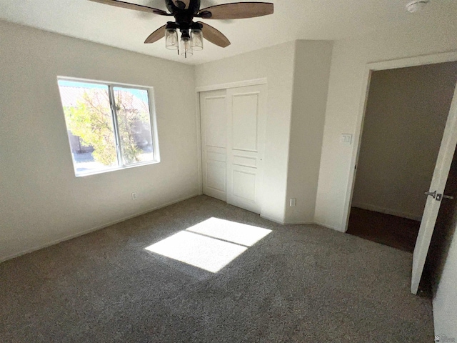 unfurnished bedroom featuring ceiling fan, a closet, and carpet