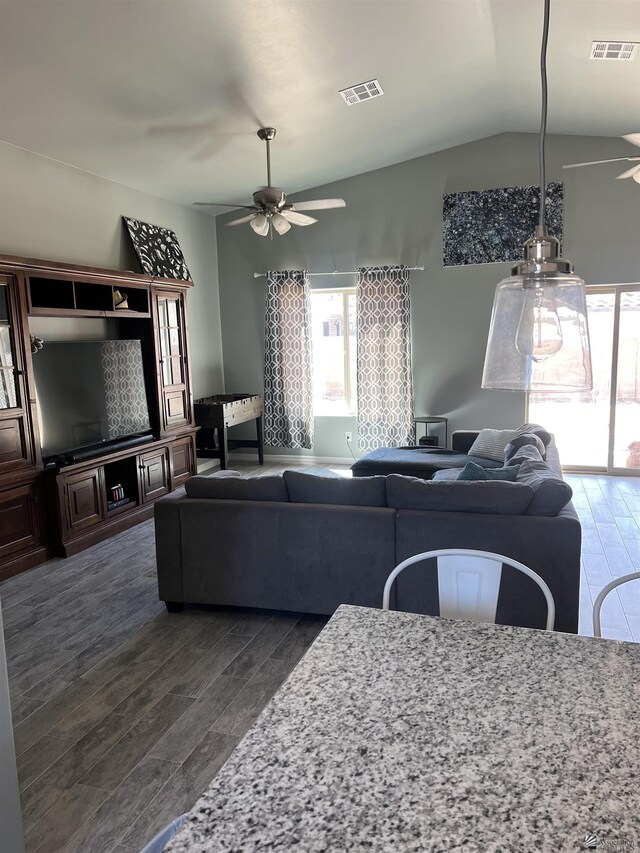 living room featuring ceiling fan, dark hardwood / wood-style flooring, and lofted ceiling