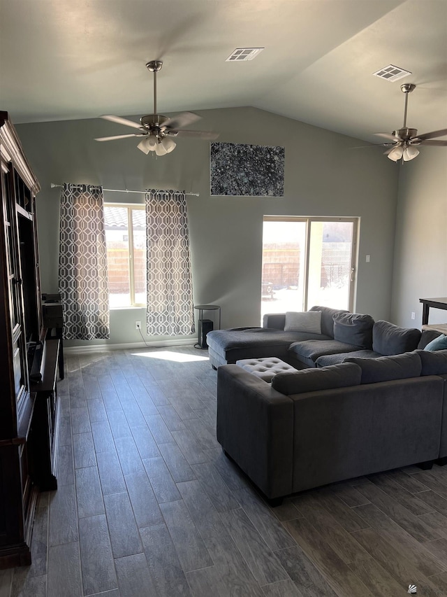 living room featuring vaulted ceiling, ceiling fan, and dark wood-type flooring