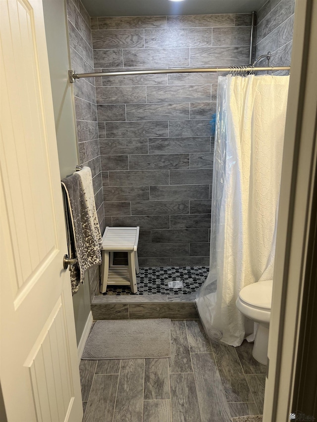 bathroom with a shower with curtain and toilet