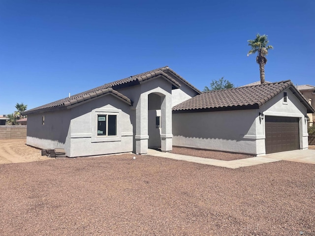 mediterranean / spanish-style home featuring a garage