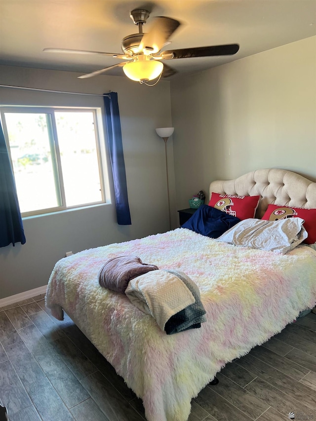 bedroom featuring ceiling fan and dark wood-type flooring