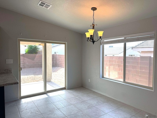 tiled spare room with an inviting chandelier, a textured ceiling, and vaulted ceiling