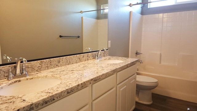 full bathroom with vanity, toilet, wood-type flooring, and shower / washtub combination