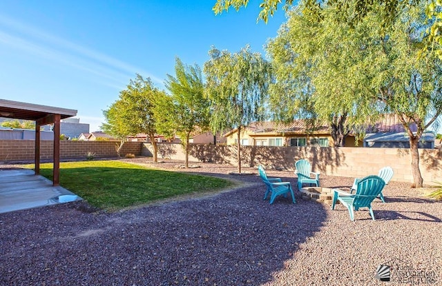 view of yard featuring an outdoor fire pit and a fenced backyard