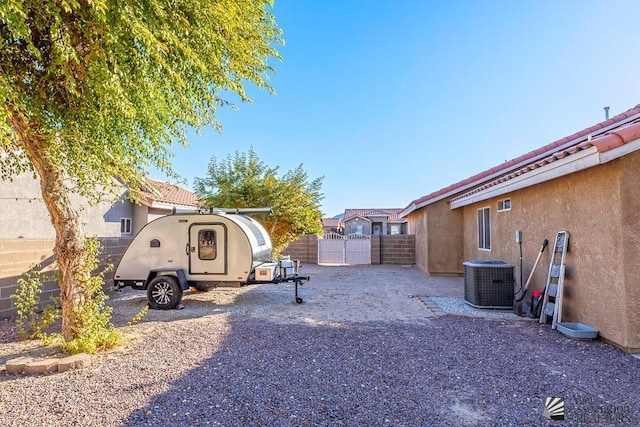 view of yard with central AC and a fenced backyard