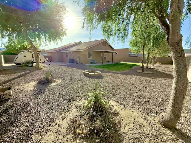 back of property featuring a patio area, fence, a fire pit, and stucco siding