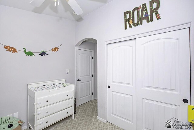 bedroom with arched walkways and a closet