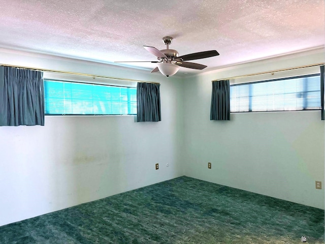 carpeted empty room featuring ceiling fan and a textured ceiling