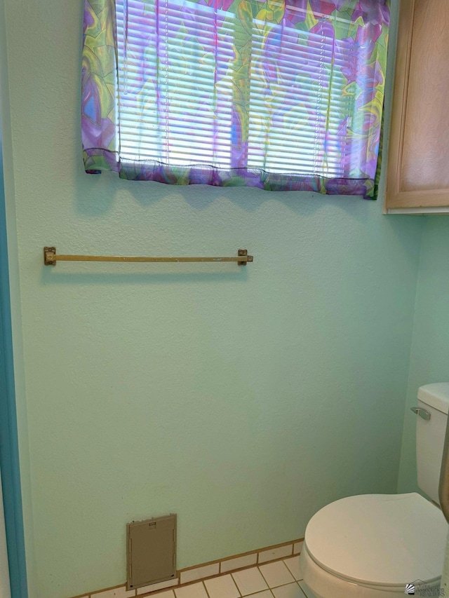 bathroom with tile patterned flooring and toilet