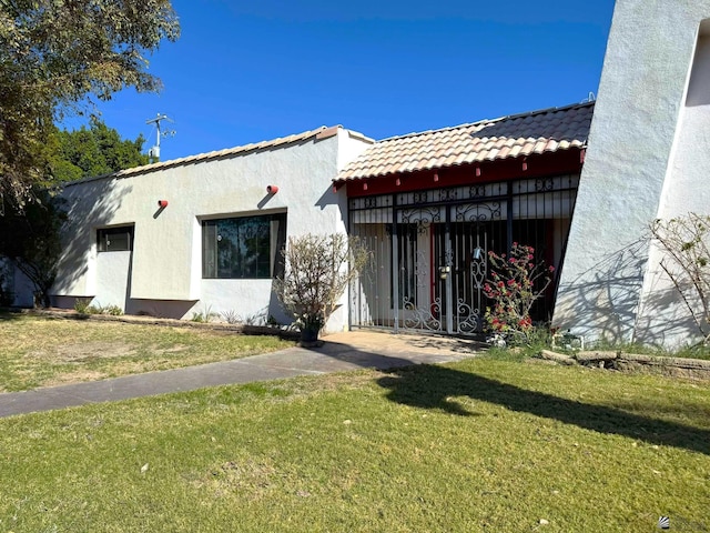 rear view of house with a lawn