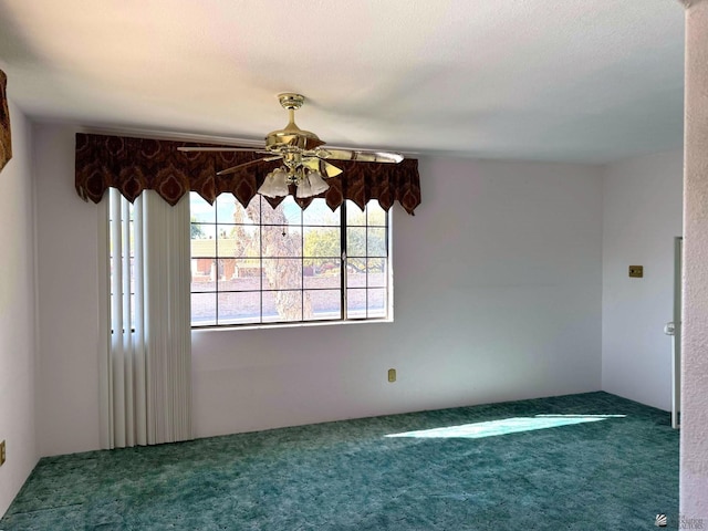 carpeted spare room featuring ceiling fan