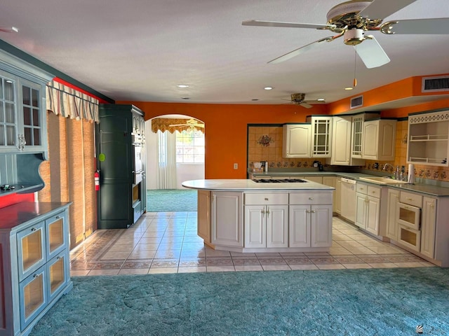 kitchen with light carpet, decorative backsplash, white appliances, sink, and cream cabinetry