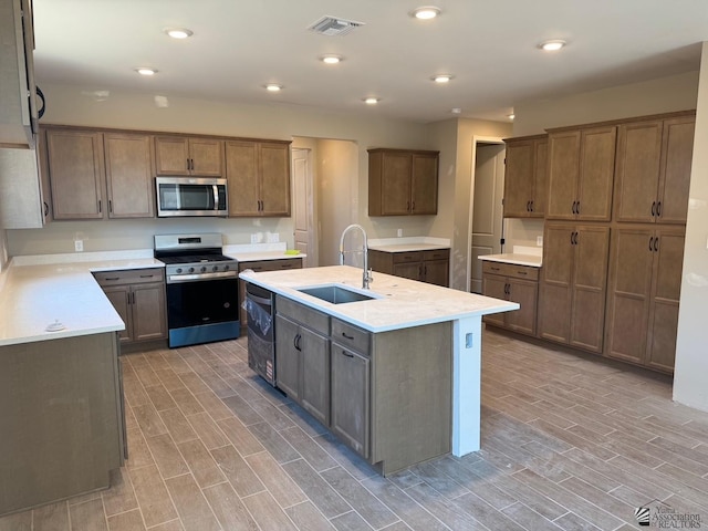 kitchen featuring sink, a center island with sink, and appliances with stainless steel finishes