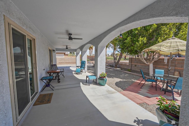 view of patio / terrace with a fenced backyard, ceiling fan, and outdoor dining space