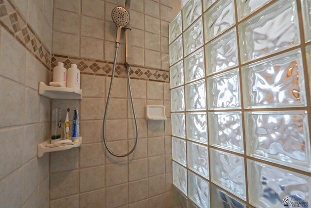 full bath featuring a tile shower