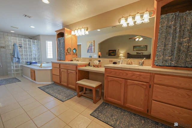 full bathroom with tile patterned flooring, visible vents, tiled shower, a bath, and vanity