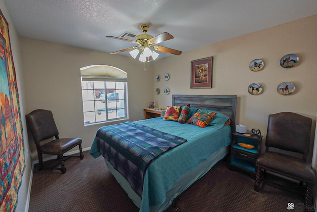 carpeted bedroom featuring visible vents, baseboards, and ceiling fan