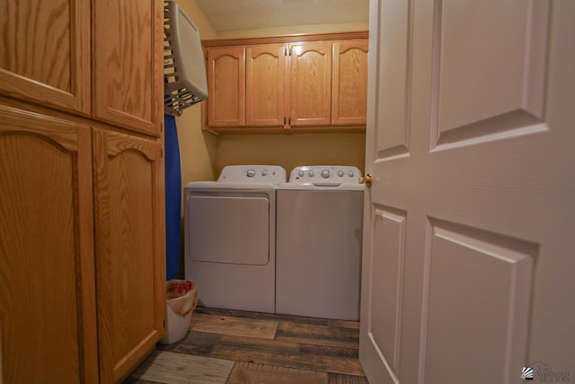 laundry area featuring cabinet space, independent washer and dryer, and dark wood-type flooring