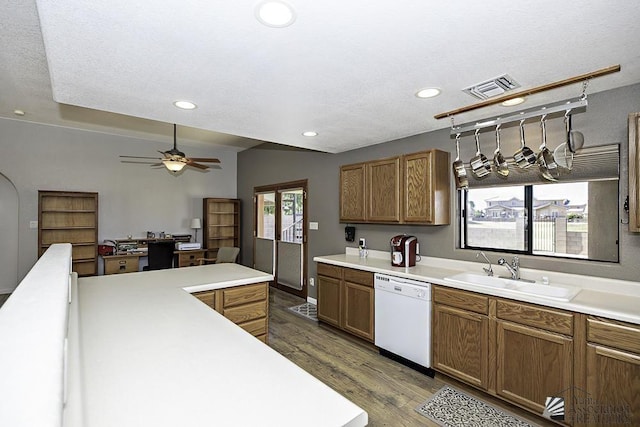 kitchen with ceiling fan, sink, dark wood-type flooring, white dishwasher, and a textured ceiling