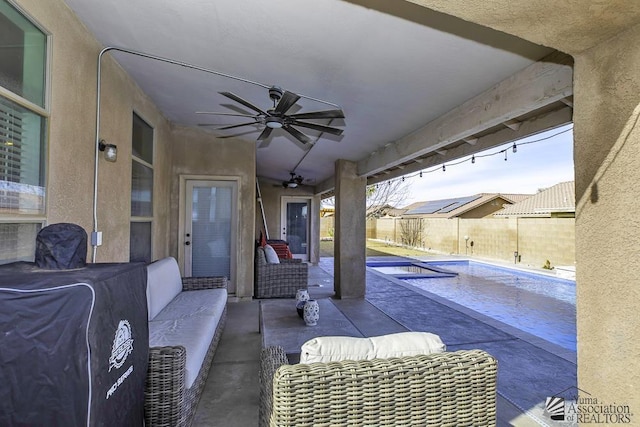 view of patio with an outdoor living space, a fenced in pool, and ceiling fan