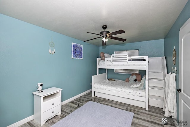 bedroom with dark hardwood / wood-style floors and ceiling fan