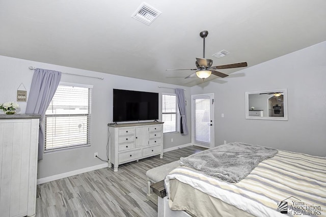 bedroom featuring ceiling fan, vaulted ceiling, and light wood-type flooring